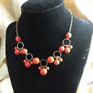 Tangerine and gold varied beaded necklace.